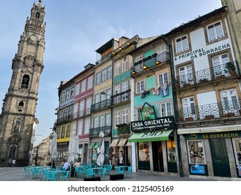 Porto, Portugal - February 12 2022. Stunning Street View Of Traditional Architecture Buildings With Colorful Azulejo Tiles Decoration, Igreja Dos Clérigos Church Tower And Street Cafe