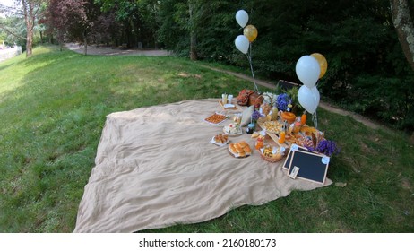 Porto, Portugal, June 27, 2021: Bachelor and bachelorette party Picnic at Porto City Party in Oporto, Portugal. Blanket with food prepared for summer picnic outdoor. 