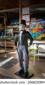 Porto, Portugal, October 2021 - Statue Of A Well Dressed Man In Top Hat And Tails, Wearing A Mask