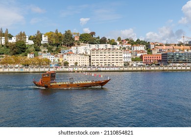 Porto, Portugal - October 23, 2020: Carlota do Douro tourist transport boat sailing on the Douro river showing the ancient city to visitors on an autumn day