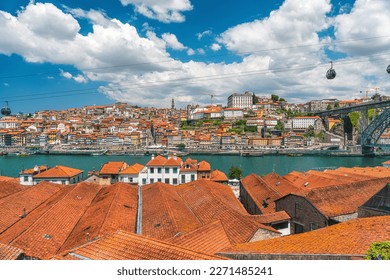 Porto, Portugal old town skyline from Gaia city on Douro river with orange rooftops and Dom Luis bridge. Oporto colorful buildings. Travel destination - Shutterstock ID 2271485241
