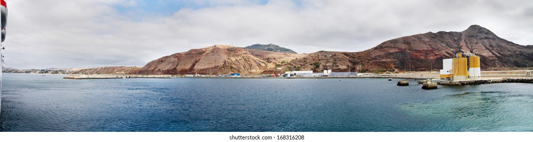 Porto Santo Harbour Of Blue Waters Under An Overcast Sky As Seen From The Ferry Boat. Madeira, Portugal.