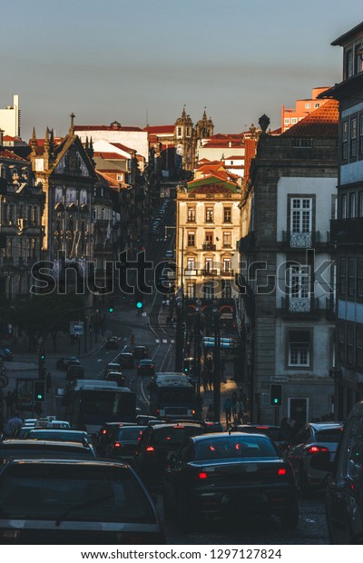 Porto\
sunset city scenery with cars during rush\
hours