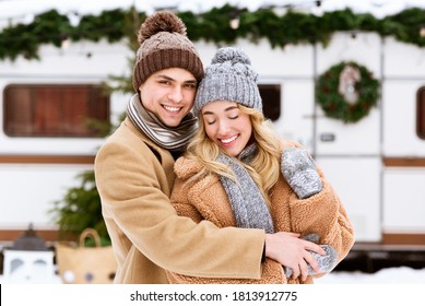 Portraif Of Loving Young Couple Cuddling Outdoors On Date In Winter Day, Hugging And Smiling, Celebrating Christmas Holidays At Camping Together, Wearing Knitted Hats And Scarfs, Copy Space