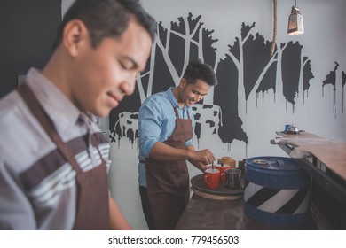 Portraif Of Two Small Cafe Owner Busy Working In Their Coffee Shop