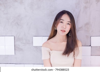 Portrain of Young Asian beautiful and pretty woman wearing open shoulder dress, off the shoulder or cutout dress with smiling emotion