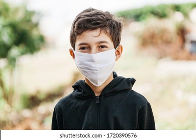 Portrait of 10 year old boy wearing homemade protective mask sunning during quarantine. Coronavirus, Covid-19 and pandemic concept - Powered by Shutterstock