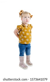 Portrait Of A 1-2 Year Old Girl Looking Up At Copy Space Hide Something Behind Back. Isolated On White Background