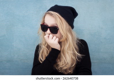 Portrait Of 13 Year Old Teenage Girl With Beenie And Glasses. Cheeky, Strong, Bold, Cocky