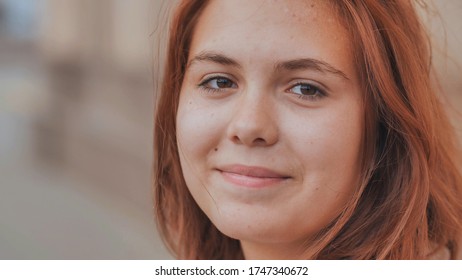 Portrait Of A 16 Year Old Red-haired Smiling Girl.