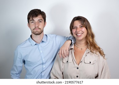 Portrait Of A 25 Year Old Young Couple Smiling And Looking At The Camera. Isolated On Gray Background
