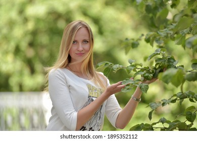 Portrait Of 30 Year Old Blonde Woman In Park