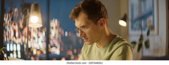 Portrait Of Of 30s Caucasian Man Staying Up Late, Using His Laptop To Work Or Study