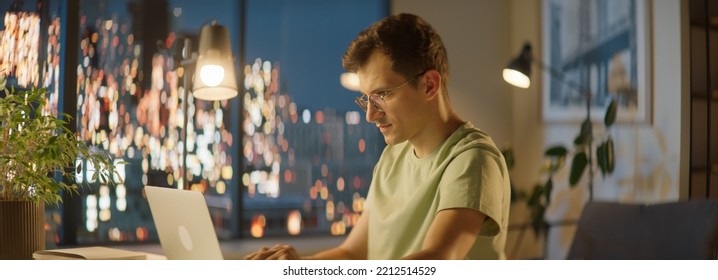 Portrait Of Of 30s Caucasian Man Staying Up Late, Using His Laptop To Work Or Study
