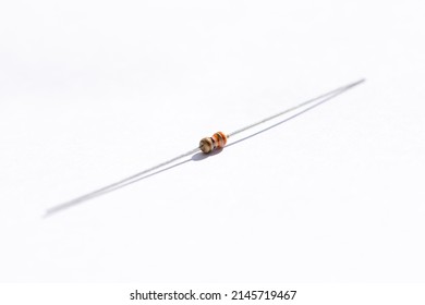 A portrait of a 330 ohm resistor with a 5% tolerance. The electric component is isolated on a white background and is ready to be used in an electronic circuit, breadboard or soldered on a PCB.
