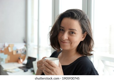 Portrait Of 38 Year Old Woman Against Home Office Background