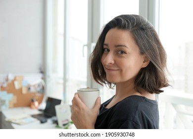 Portrait Of 38 Year Old Woman Against Home Office Background