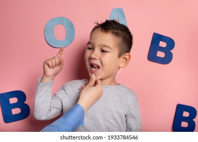 Portrait Of A 4 Year Old Boy  Speech Therapy Concept On Pink  Background. Correct Pronunciation And Articulation At Preschool Age.