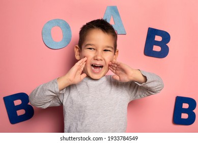 Portrait Of A 4 Year Old Boy  Speech Therapy Concept On Pink  Background. Correct Pronunciation And Articulation At Preschool Age.