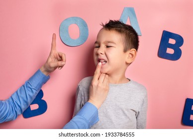 Portrait Of A 4 Year Old Boy  Speech Therapy Concept On Pink  Background. Correct Pronunciation And Articulation At Preschool Age.