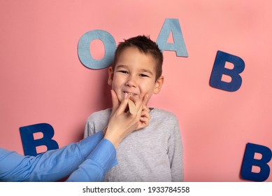 Portrait Of A 4 Year Old Boy  Speech Therapy Concept On Pink  Background. Correct Pronunciation And Articulation At Preschool Age.