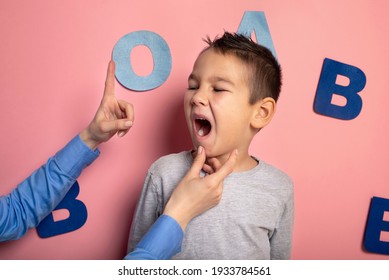 Portrait Of A 4 Year Old Boy  Speech Therapy Concept On Pink  Background. Correct Pronunciation And Articulation At Preschool Age.