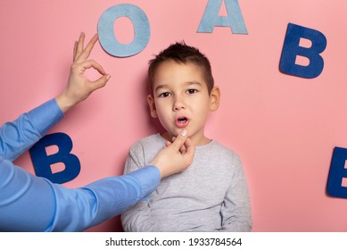 Portrait Of A 4 Year Old Boy  Speech Therapy Concept On Pink  Background. Correct Pronunciation And Articulation At Preschool Age.