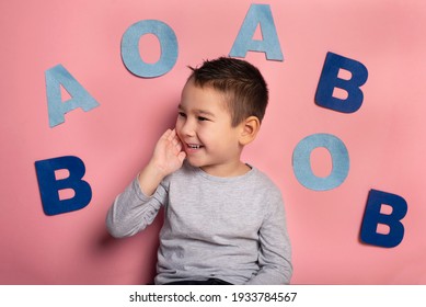 Portrait Of A 4 Year Old Boy  Speech Therapy Concept On Pink  Background. Correct Pronunciation And Articulation At Preschool Age.