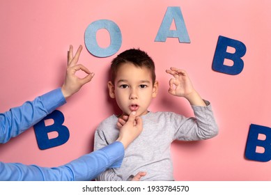 Portrait Of A 4 Year Old Boy  Speech Therapy Concept On Pink  Background. Correct Pronunciation And Articulation At Preschool Age.