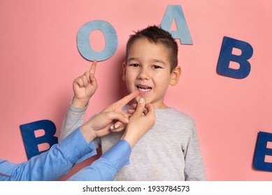 Portrait Of A 4 Year Old Boy  Speech Therapy Concept On Pink  Background. Correct Pronunciation And Articulation At Preschool Age.