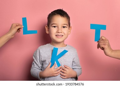 Portrait Of A 4 Year Old Boy  Speech Therapy Concept On Pink  Background. Correct Pronunciation And Articulation At Preschool Age.