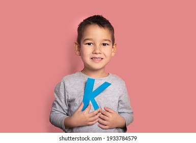 Portrait Of A 4 Year Old Boy  Speech Therapy Concept On Pink  Background. Correct Pronunciation And Articulation At Preschool Age.