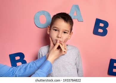 Portrait Of A 4 Year Old Boy  Speech Therapy Concept On Pink  Background. Correct Pronunciation And Articulation At Preschool Age.