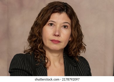 Portrait Of 40 Year Old Hispanic Woman, Short Curly Hair.