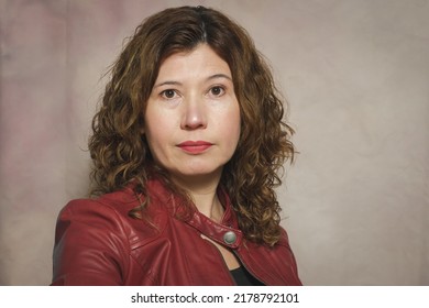 Portrait Of 40 Year Old Hispanic Woman, Short Curly Hair.