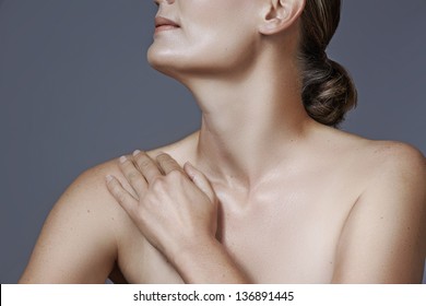 Portrait Of 40 Year Old Woman With Beautiful Skin And Natural Makeup On Studio Background