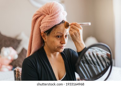 Portrait Of A 40 Year Old Woman Applying Makeup