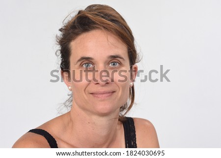 portrait of a 40 year old woman without makeup on white background
