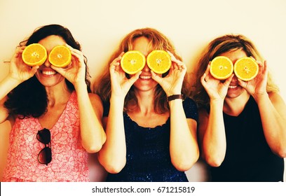 Portrait Of 40 Years Old Woman Holding Oranges