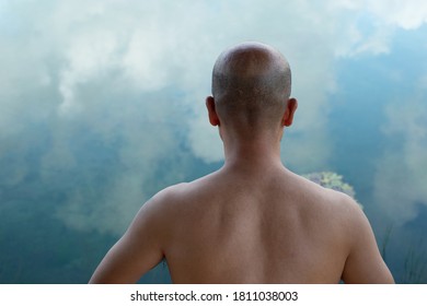 portrait of 40s topless Asian Japanese skin head bald beard man with summer blue nature sky reflection in lake water background