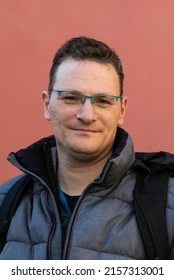 Portrait Of A 43 Year Old Serious White Man With A Salmon Pink Background