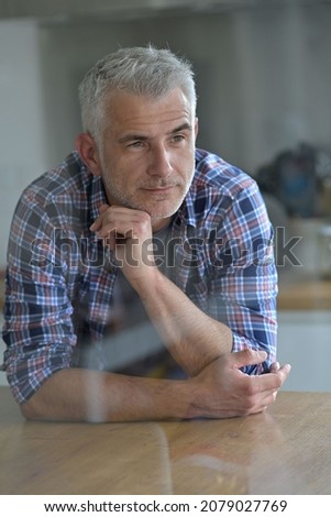 portrait of a 45 year old man inside his house