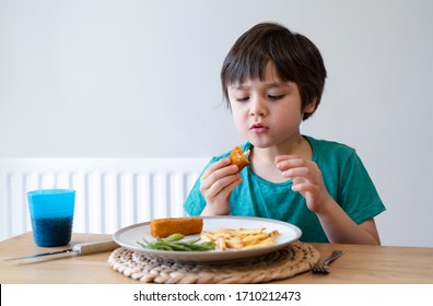 Portrait Of 5 Year Old Kid Boy Having Homemade Fish Finger And French Fries For Sunday Dinner At Home, A Happy Child Eating Lunch, Children Eating Heathy And Fresh Food, Healthy Life Style Concept