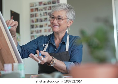 Portrait Of A 55 Year Old Senior Woman Doing Art Painting