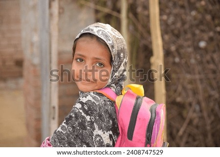 Portrait of 6 Year old girl student from Punjab Pakistan. Pakistani baby girl wearing school bag and ready to go to school. Education concept. Education village of Pakistan. Asian people from Pakistan