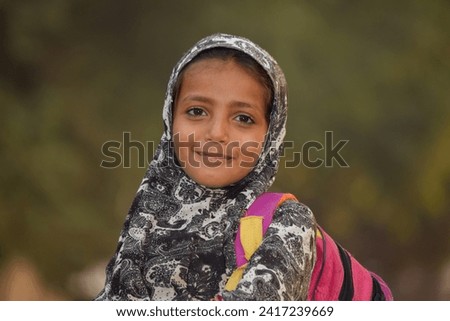 Portrait of 6 Year old girl student from Punjab Pakistan. Pakistani baby girl wearing school bag and ready to go to school. Education concept. Education village of Pakistan. Asian people from Pakistan
