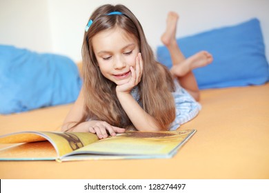 Portrait Of 6 Years Old Child Reading Book At Home