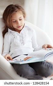 Portrait Of 6 Years Old Child Reading Book At Home