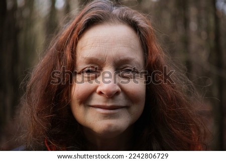 Portrait of a 60 year old smiling woman without make-up