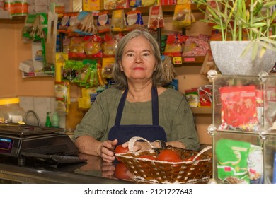 Portrait Of A 60-year-old Woman, Owner Of A Small Grocery Store.